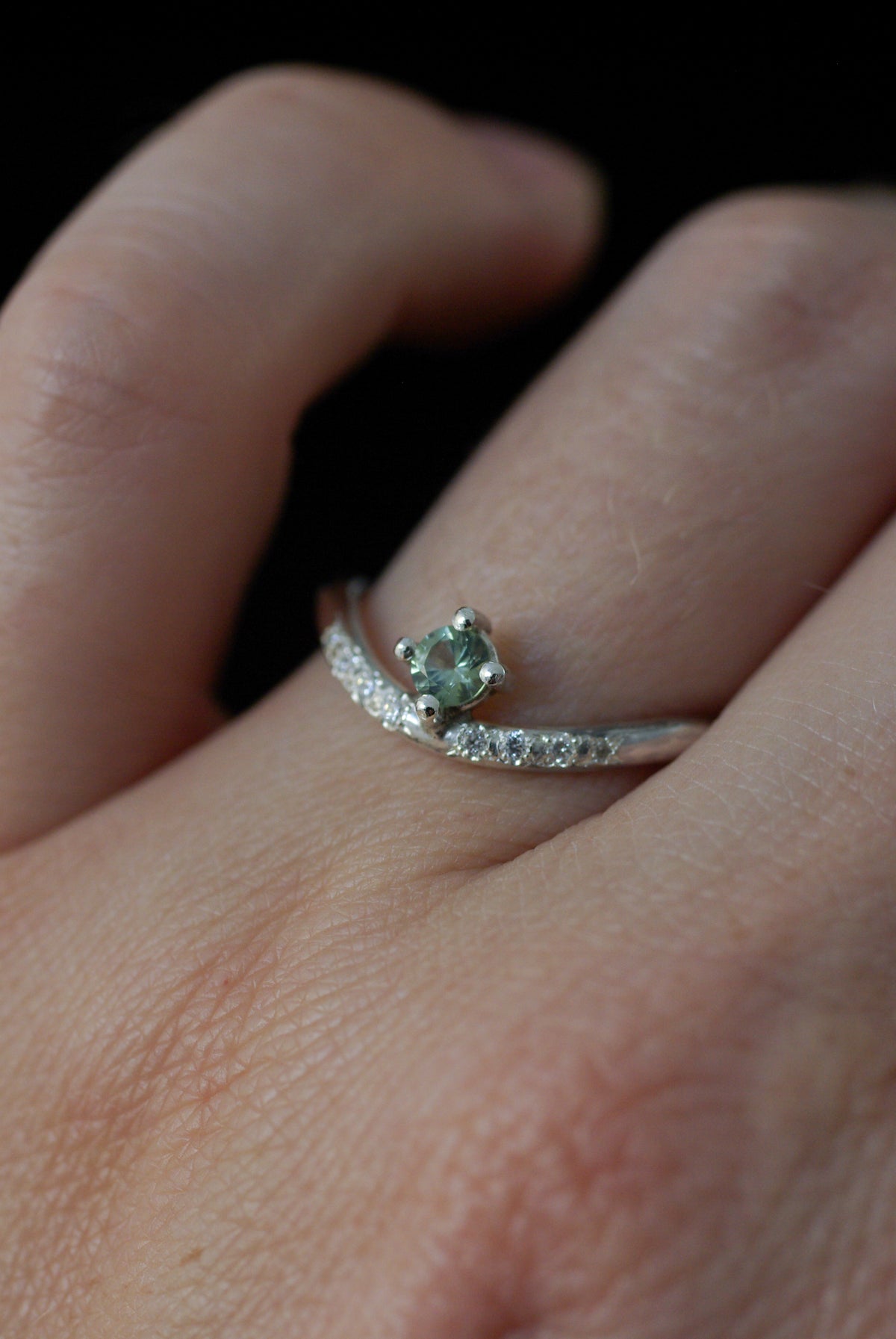 vue portée d'une Bague en argent, saphir vert et diamants sertis sur un anneau ondulé