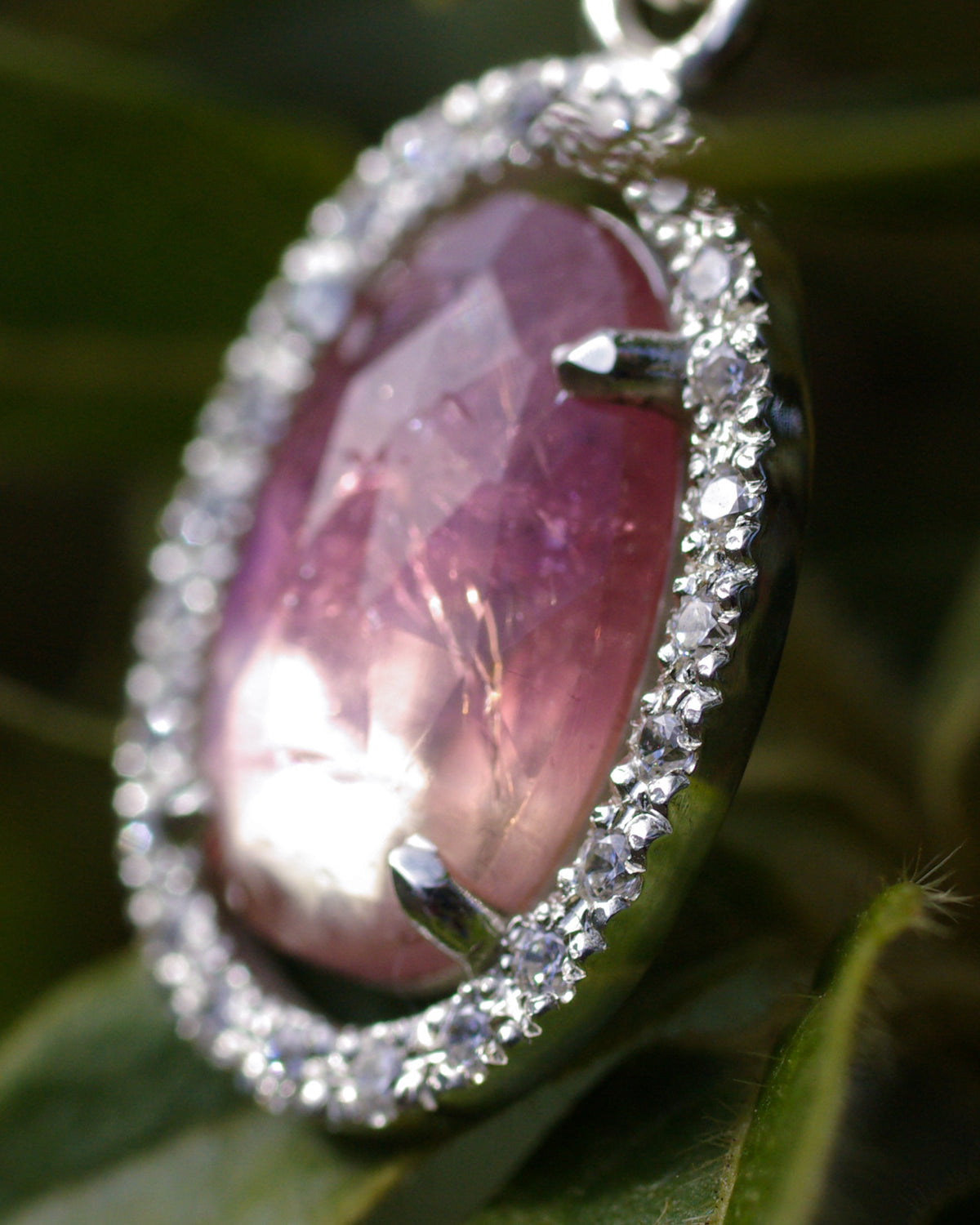 Détail du halo entourage d’oxydes de zirconium autour de la tourmaline rose bicolore sur un pendentif artisanal